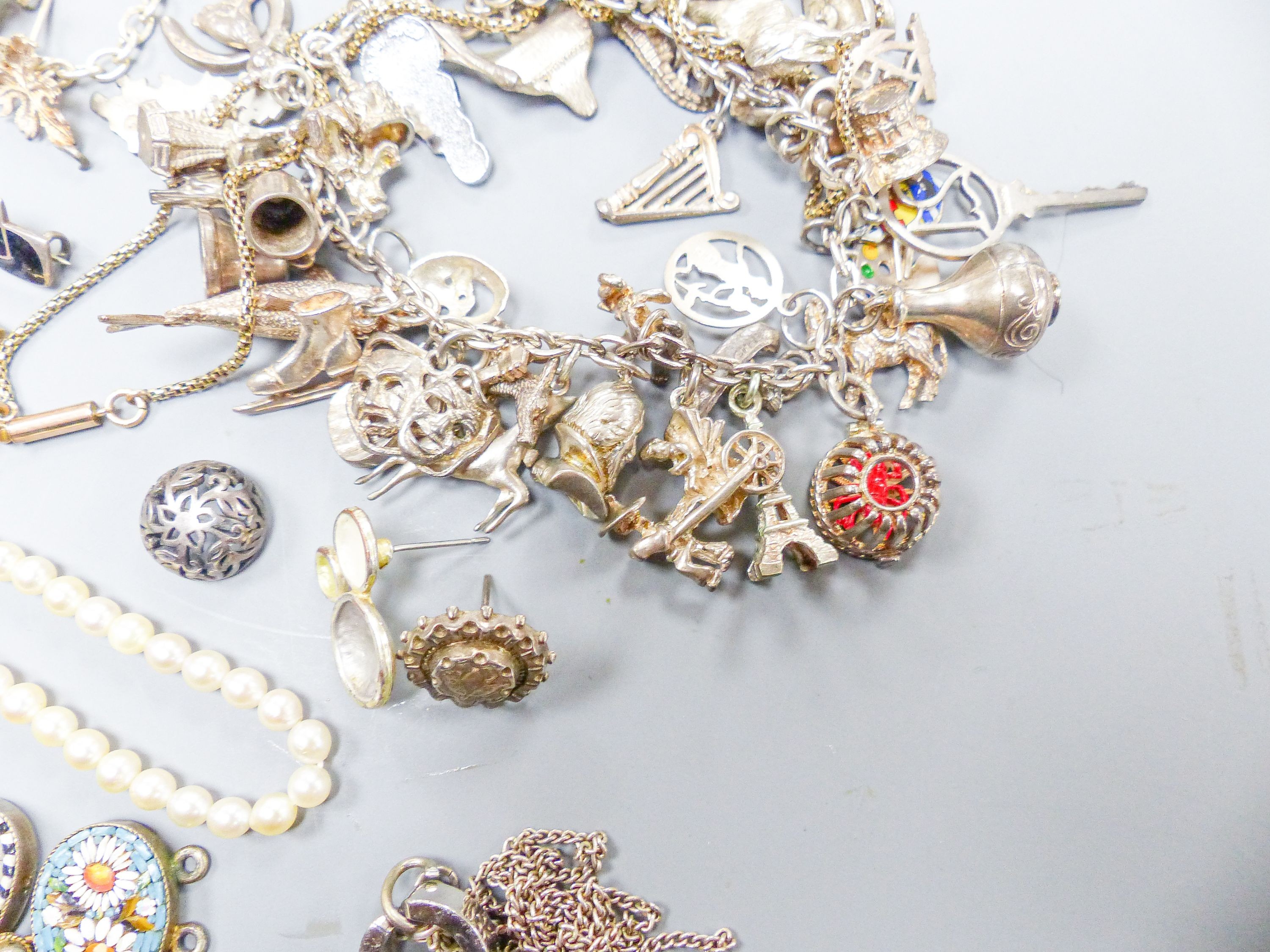 Assorted gold and silver jewellery including bar brooches, charm bracelet etc.